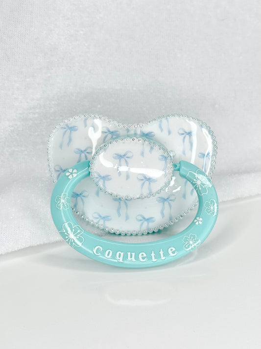 Coquette blue vinyl image heat sealed adult sized pacifier